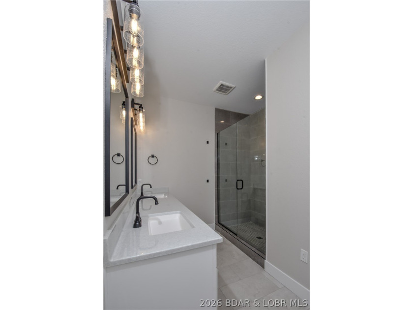 BRAND NEW HOME in the HEART of Osage Beach!! This striking home - photo 28