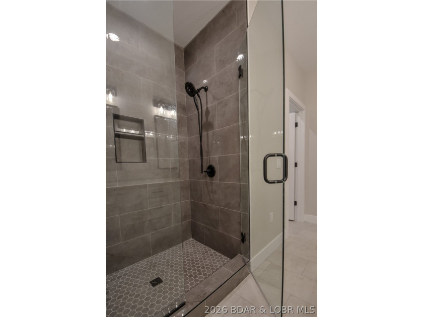 BRAND NEW HOME in the HEART of Osage Beach!! This striking home - photo 29
