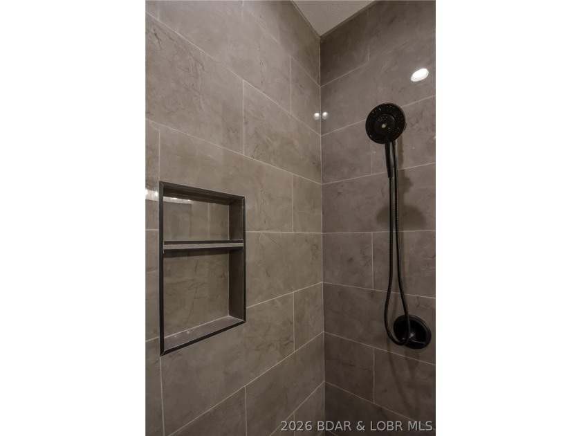 BRAND NEW HOME in the HEART of Osage Beach!! This striking home - photo 31