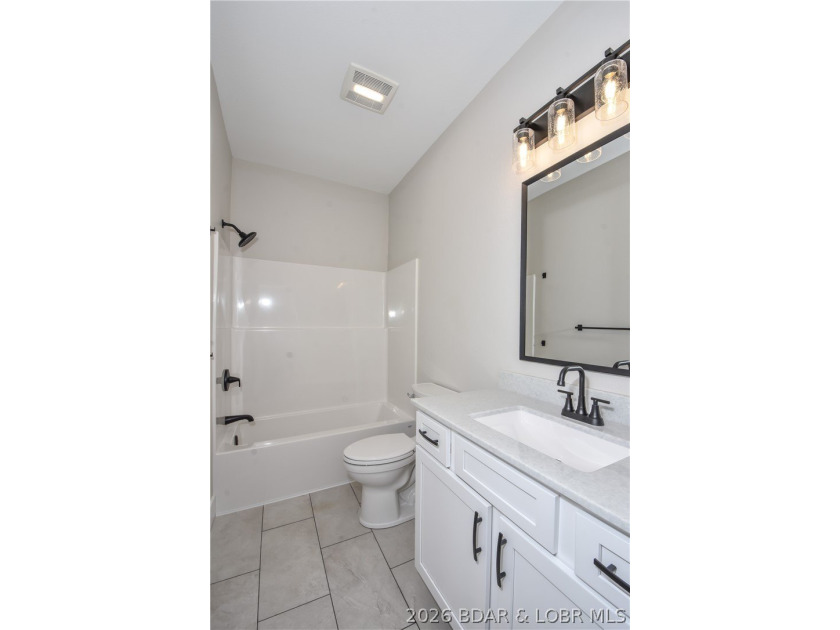 BRAND NEW HOME in the HEART of Osage Beach!! This striking home - photo 37