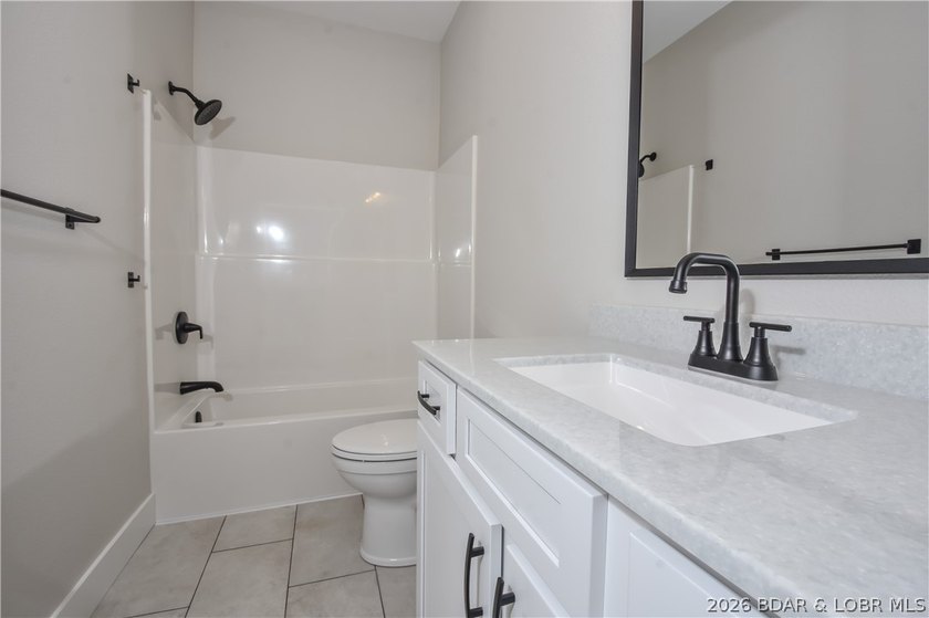 BRAND NEW HOME in the HEART of Osage Beach!! This striking home - photo 38