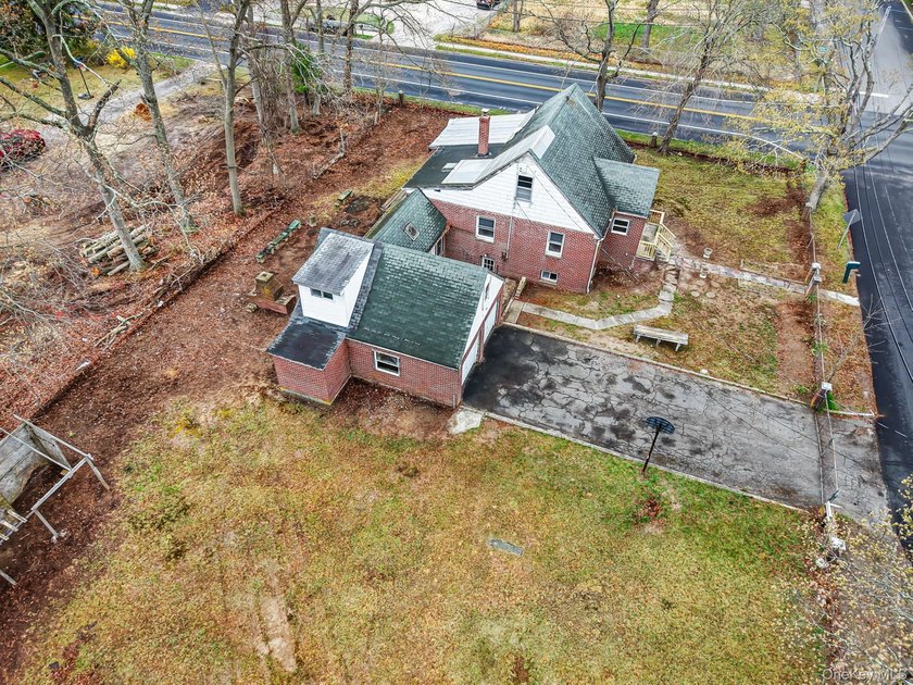 This spacious corner property nestled on a estimated half-acre - photo 15