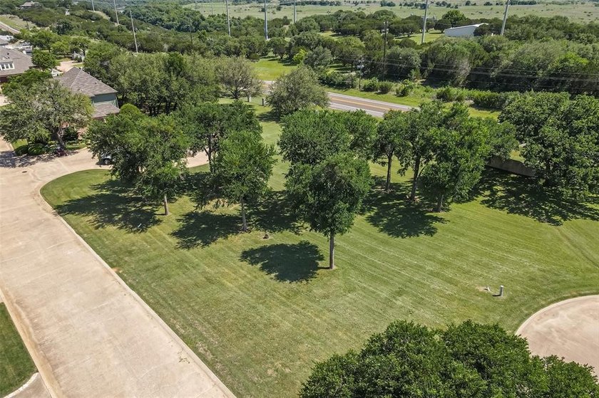 Nestled on a quiet street within the prestigious gated Bluff - photo 3