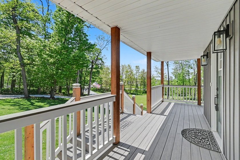 Tucked among the trees on 2 scenic acres just outside the - photo 3
