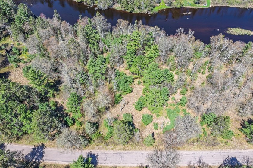 This 1.16-acre wooded parcel with 210 feet of frontage on the - photo 20