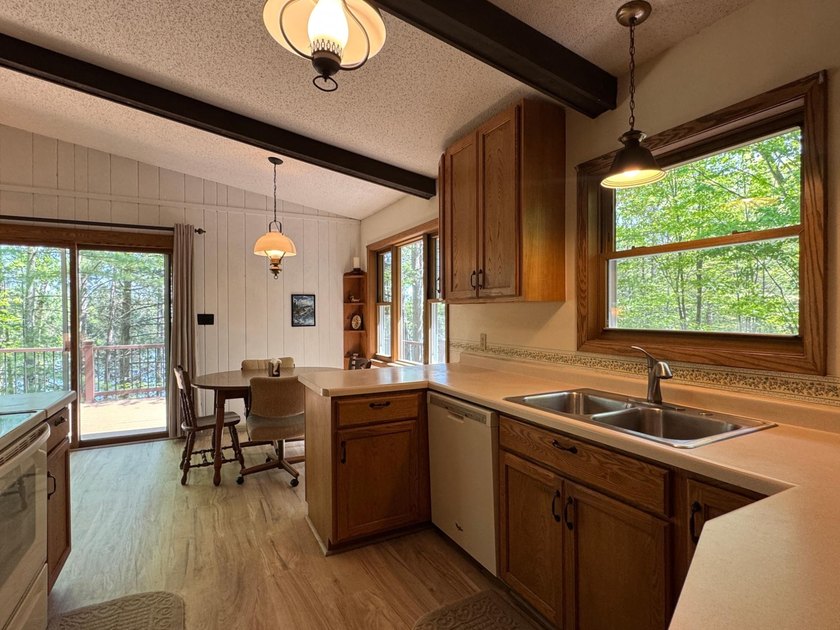Nestled on a wooded lot on beautiful 204 AC BOOTH lake, this - photo 16