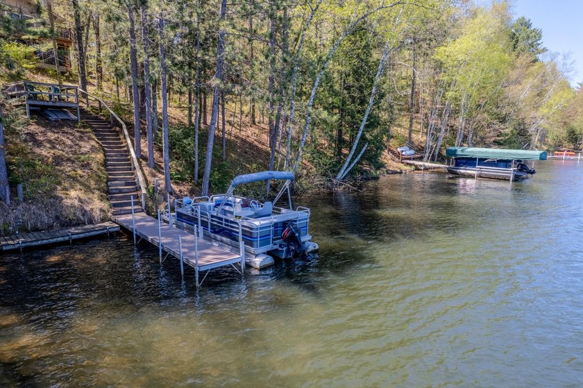 Nestled on a wooded lot on beautiful 204 AC BOOTH lake, this - photo 37