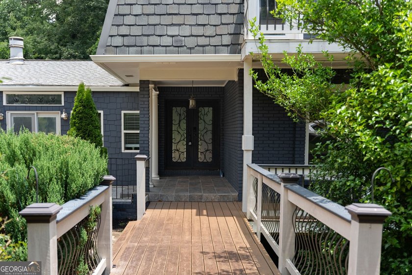 Nestled on a private wooded lot in the highly sought-after - photo 4