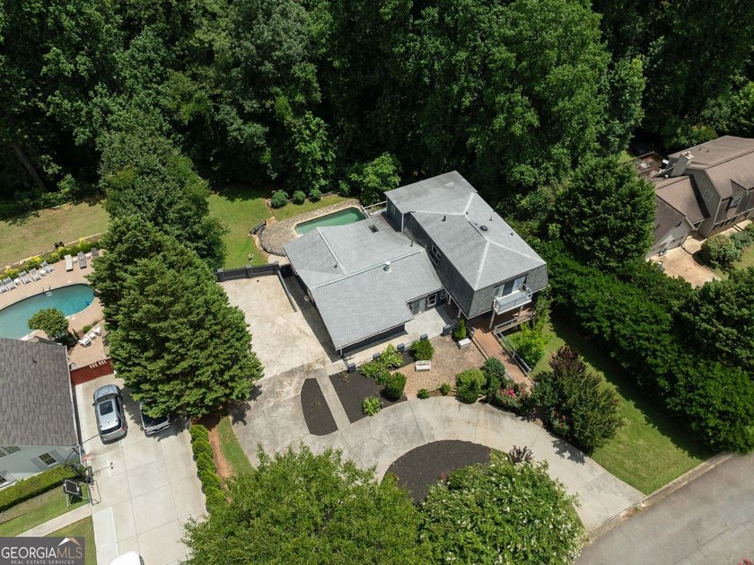 Nestled on a private wooded lot in the highly sought-after - photo 8