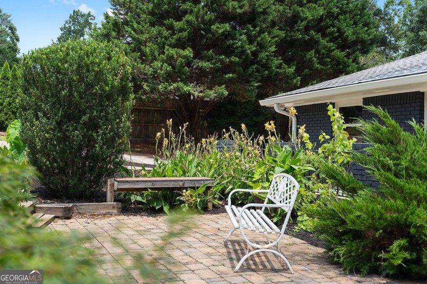 Nestled on a private wooded lot in the highly sought-after - photo 9