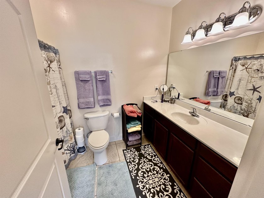 Welcome to this elegant three-bedroom, two-bathroom condominium - photo 15