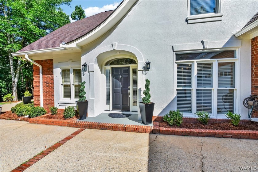 Nestled on a wooded golf course lot in the sought-after - photo 5