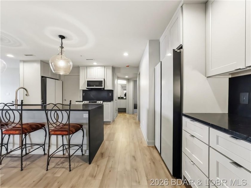 Turnkey luxury and breathtaking lakefront views await in this - photo 12