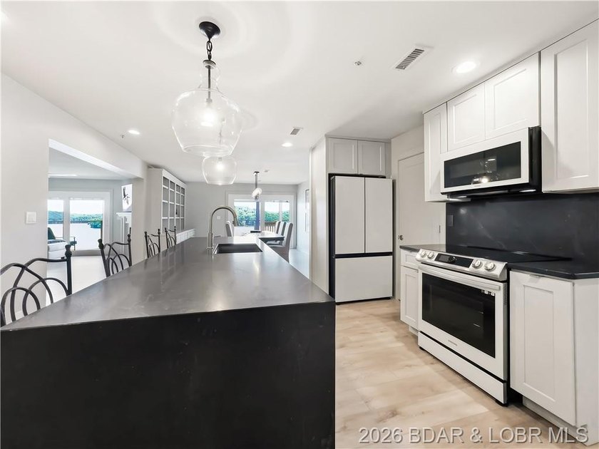 Turnkey luxury and breathtaking lakefront views await in this - photo 13