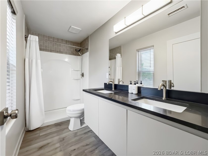 Turnkey luxury and breathtaking lakefront views await in this - photo 21