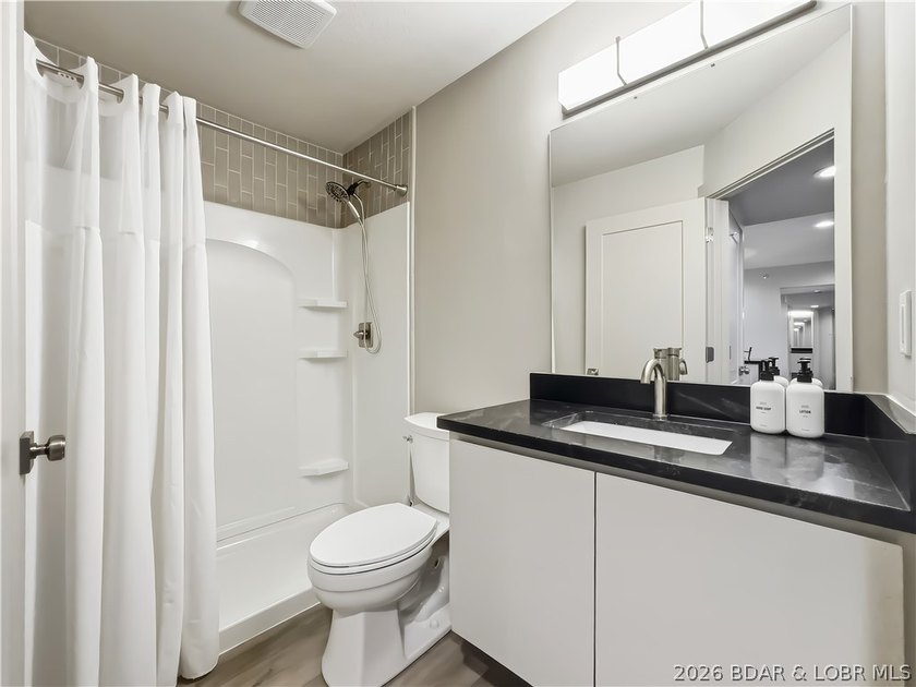 Turnkey luxury and breathtaking lakefront views await in this - photo 26