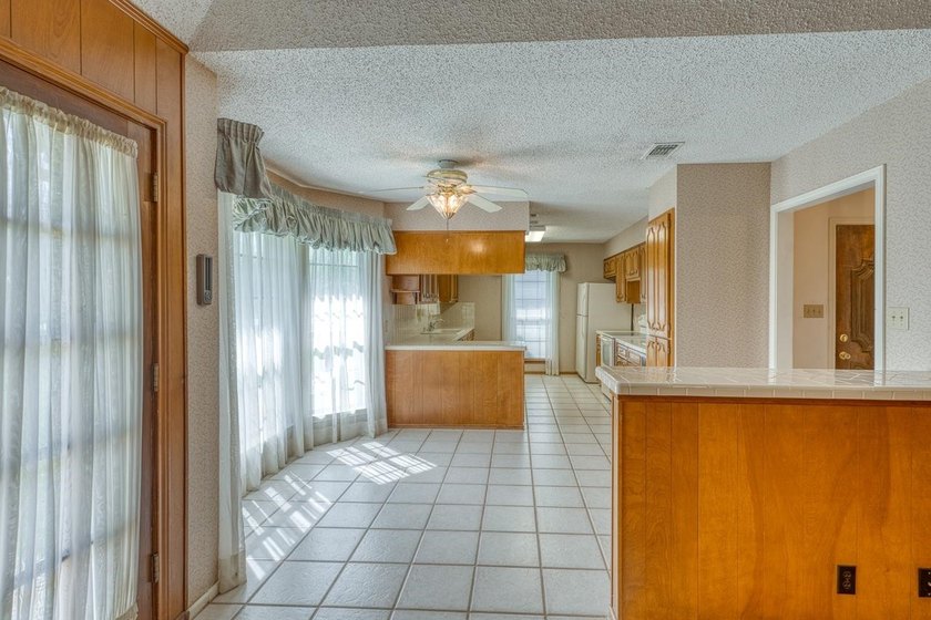 Opportunity awaits in this quaint brick home with a tile roof - photo 5