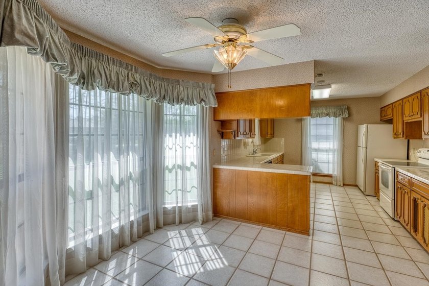 Opportunity awaits in this quaint brick home with a tile roof - photo 6