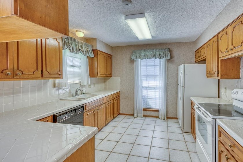 Opportunity awaits in this quaint brick home with a tile roof - photo 8