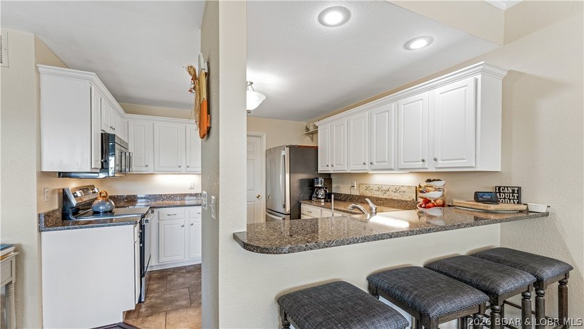 Walk-in, no steps, attached garage, lake views, and very low - photo 11