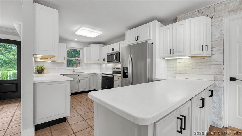 Lakefront living at its finest! This updated 4-bedroom, 3-bath - photo 13