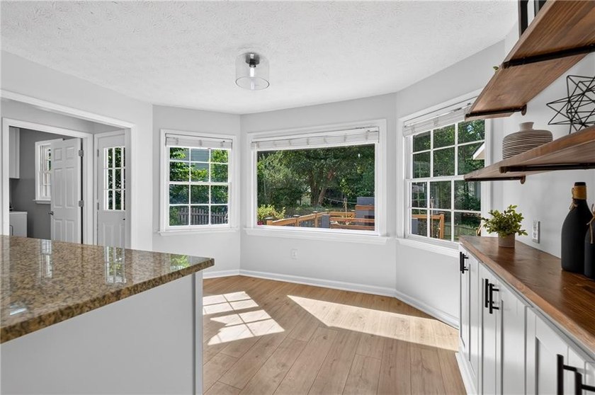 Tucked into a private wooded lot with a stunning lake view in - photo 14