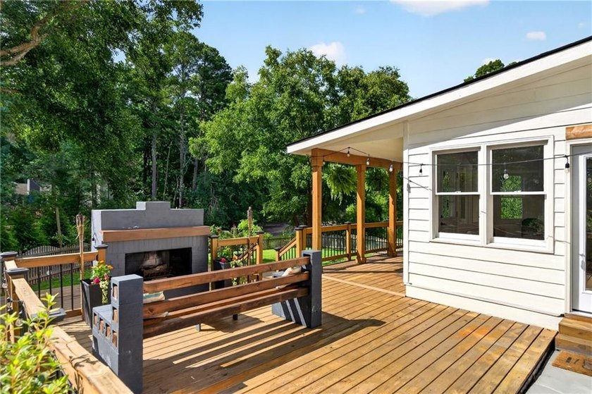 Tucked into a private wooded lot with a stunning lake view in - photo 44