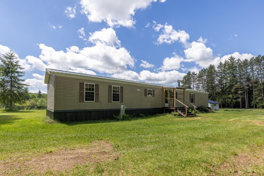 Set on nearly 25 acres along the scenic Deerskin River in Phelps - photo 12