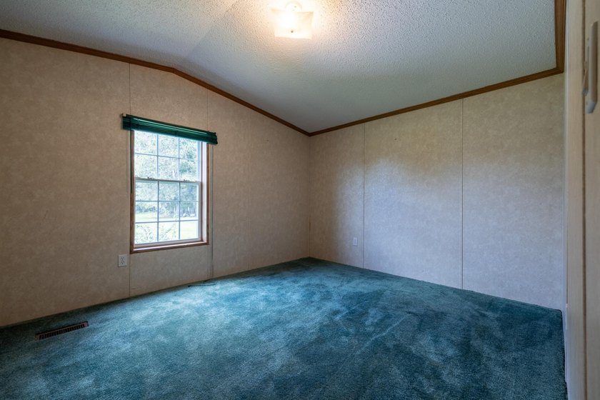 Set on nearly 25 acres along the scenic Deerskin River in Phelps - photo 16