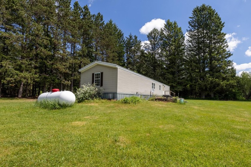 Set on nearly 25 acres along the scenic Deerskin River in Phelps - photo 25