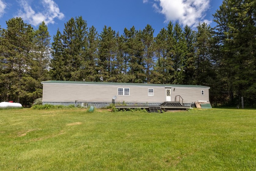 Set on nearly 25 acres along the scenic Deerskin River in Phelps - photo 26