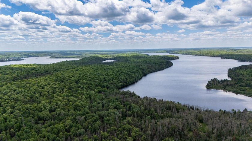 Set on nearly 25 acres along the scenic Deerskin River in Phelps - photo 48