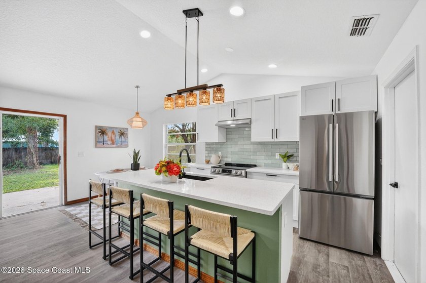 Set on an oversized .46-acre lot with mature trees, this - photo 4