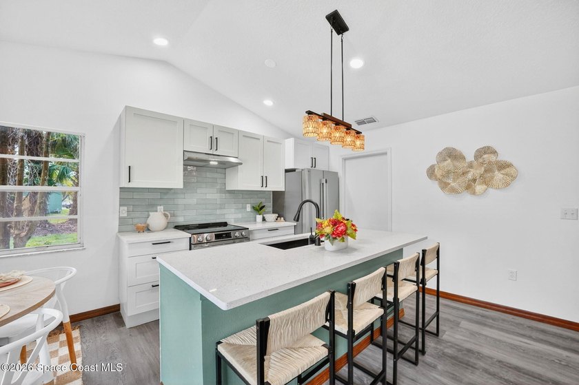 Set on an oversized .46-acre lot with mature trees, this - photo 5