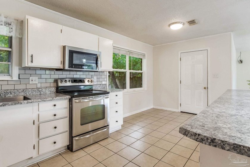 Step into the delightful 3-bedroom, 2-bath haven nestled in the - photo 3