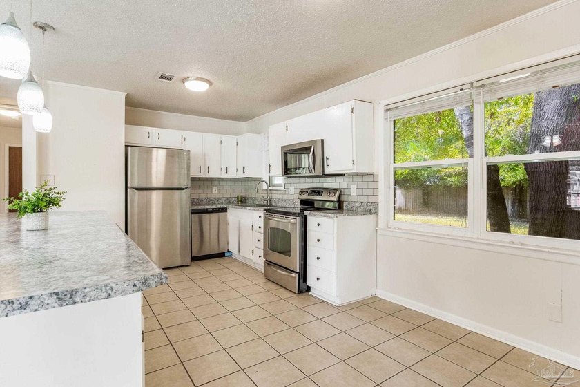 Step into the delightful 3-bedroom, 2-bath haven nestled in the - photo 7