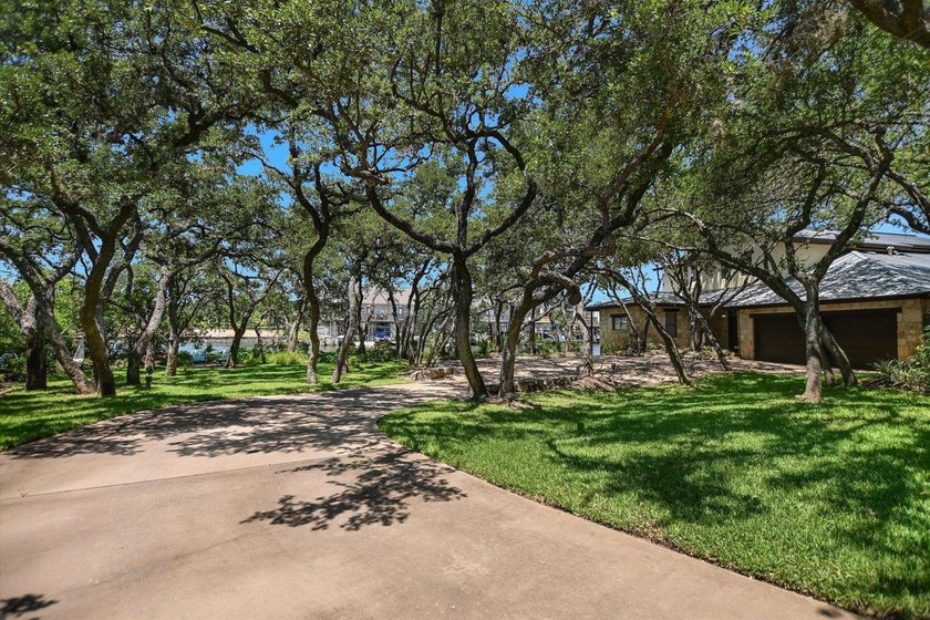 Beyond a gated entrance and beneath a canopy of mature live oaks - photo 4