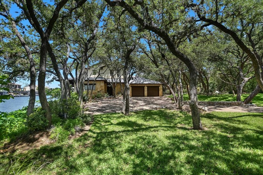 Beyond a gated entrance and beneath a canopy of mature live oaks - photo 5