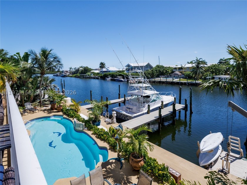 A rare waterfront estate along a 200-foot wide canal with a - photo 3