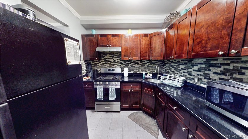This beautifully maintained legal 3-family semi-detached home - photo 5