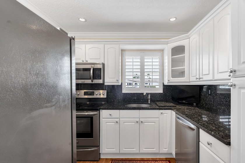 Welcome to this beautifully updated villa, featuring a spacious - photo 14