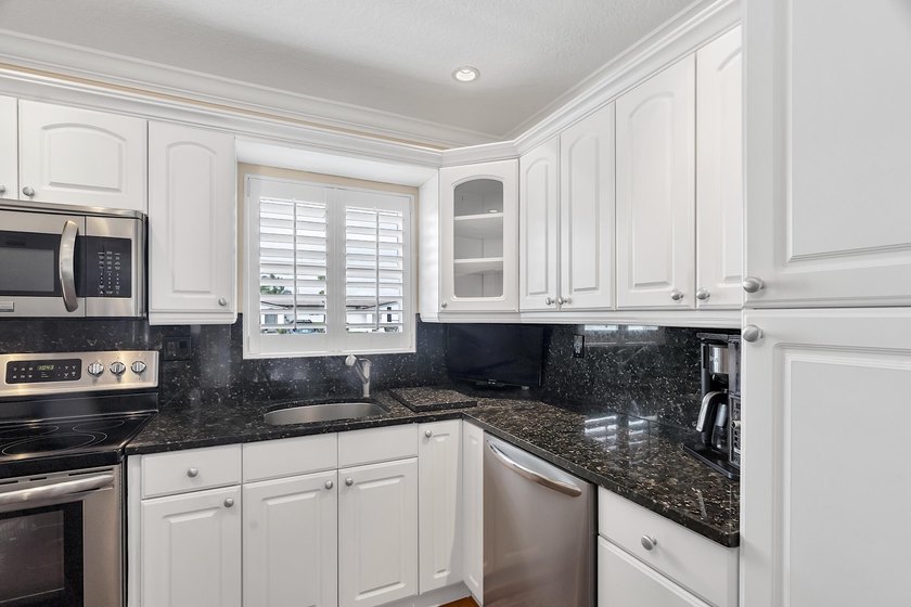 Welcome to this beautifully updated villa, featuring a spacious - photo 15