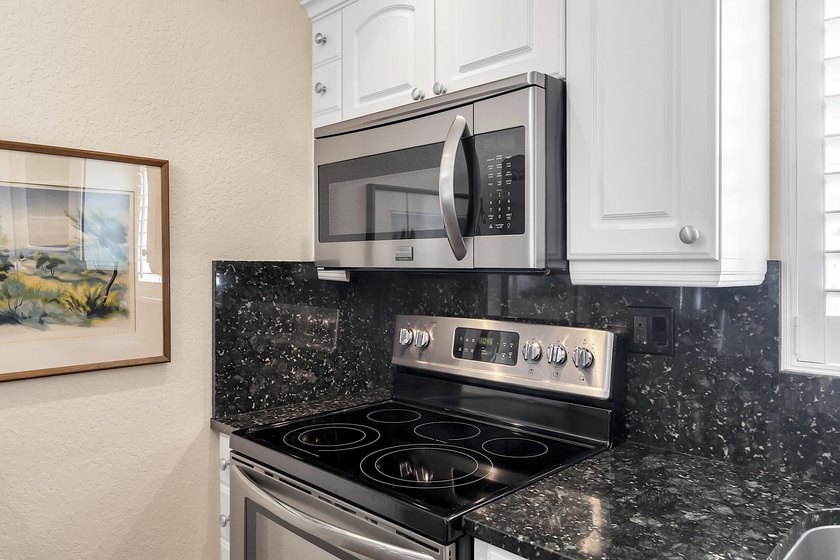 Welcome to this beautifully updated villa, featuring a spacious - photo 18