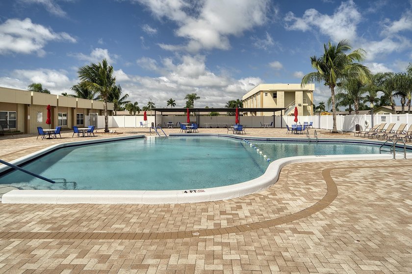 Welcome to this beautifully updated villa, featuring a spacious - photo 38