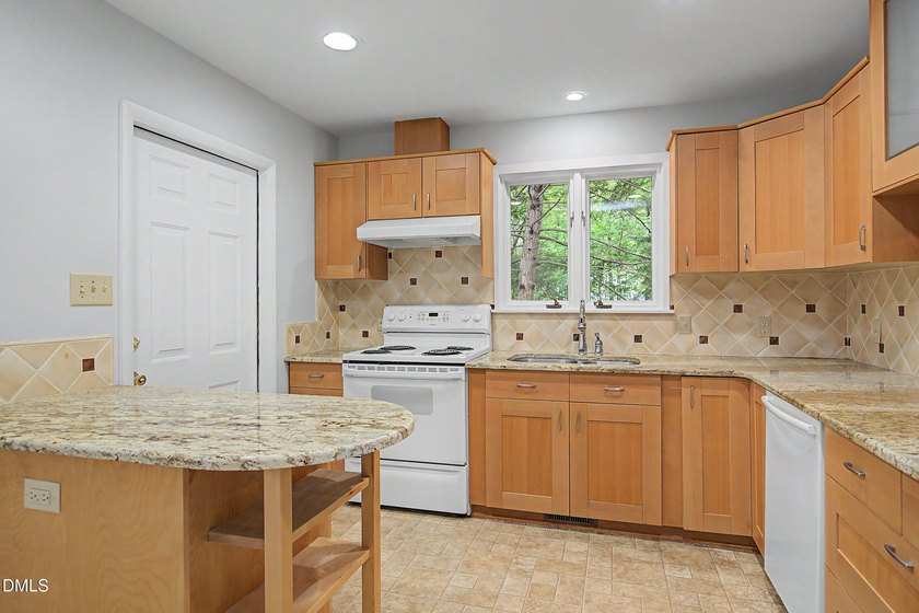 Tucked away on a sprawling corner lot of over 1/2 an acre in the - photo 2