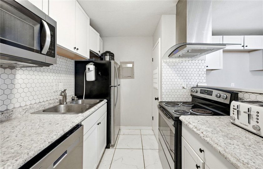 Desirable Lakewood Village featuring laminate and tile flooring - photo 6