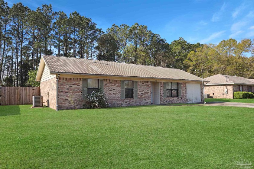 Set on a spacious lot with a durable metal roof, this - photo 3