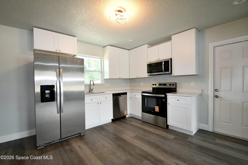 This updated Palm Bay home is set just off a main road, making - photo 4