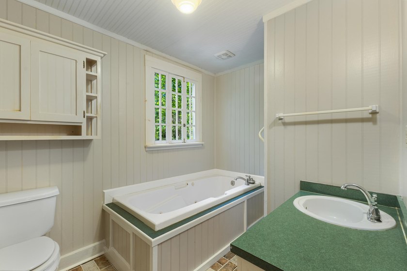 Hidden beneath towering hardwoods on a private wooded setting - photo 33