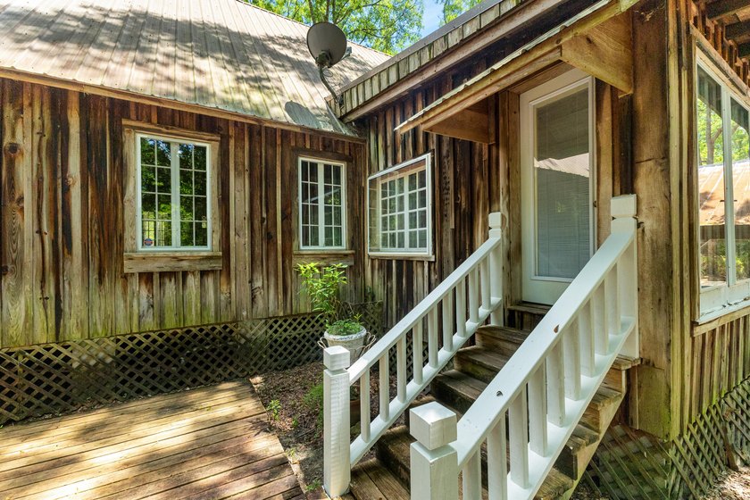 Hidden beneath towering hardwoods on a private wooded setting - photo 34